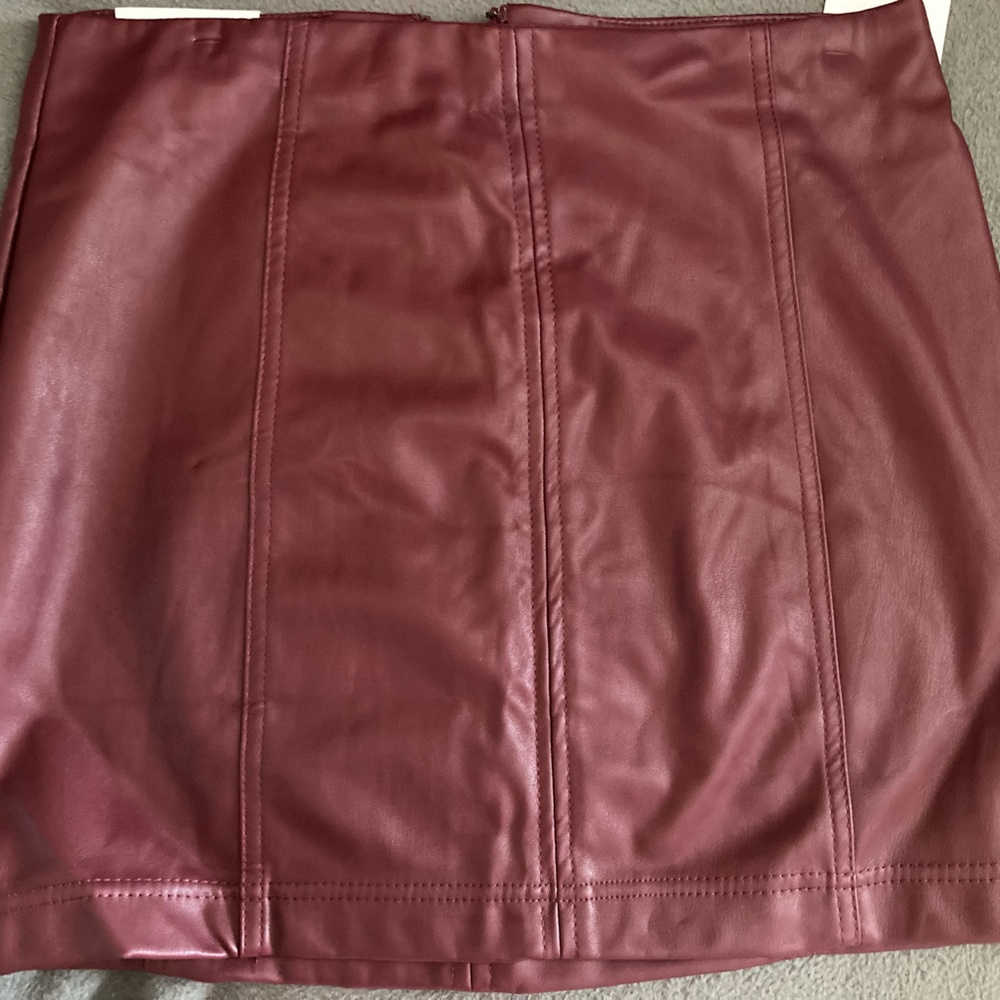 NWT burgundy faux leather skirt.